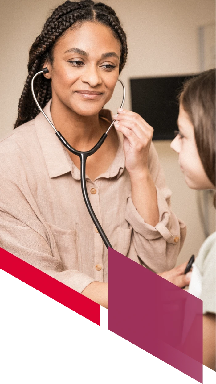 A locums physician listens with her stethoscope while examining her patient.